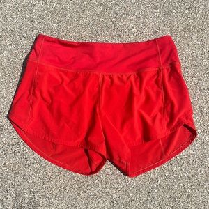 Red-orange lululemon 4 inch speed up shorts size 6